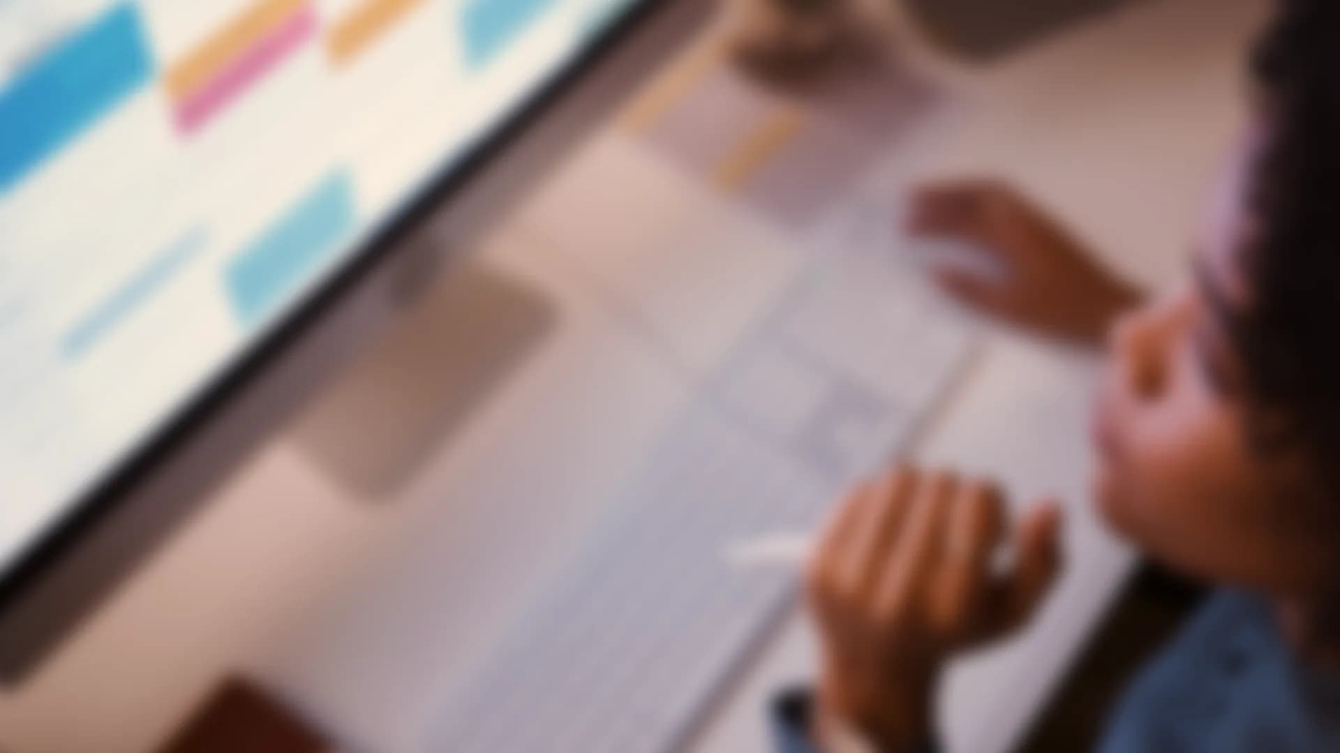 An advisor at a desk with a calendar on screen, out of focus
